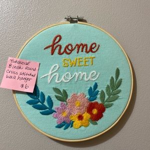 8” round embroidery hoop turquoise background with colorful image.